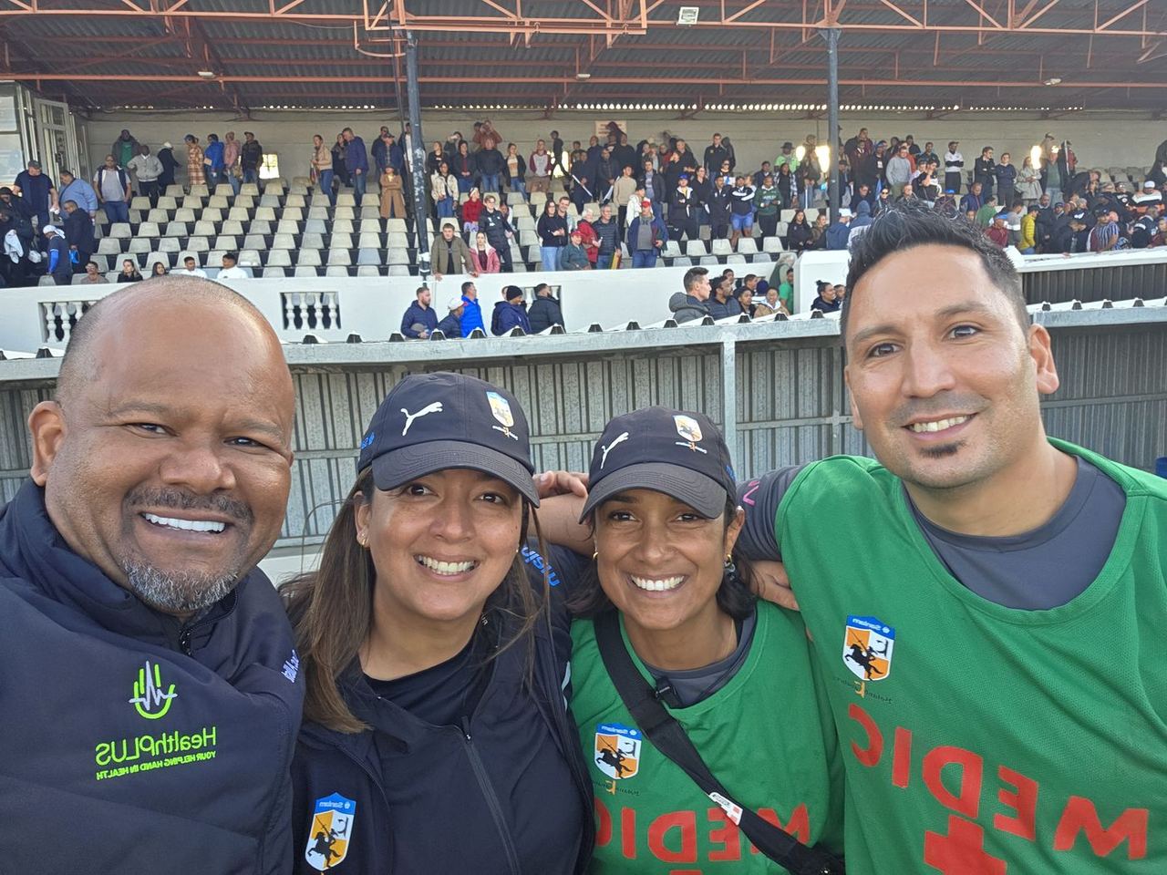 HealthPLUS medical team selfie at a Boland rugby stadium; Dr Arthur Williams on the far left in a HealthPLUS jacket