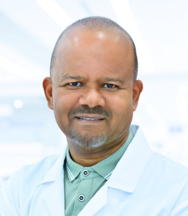 Dr Arthur Williams, sports medicine specialist at HealthPLUS in a white coat